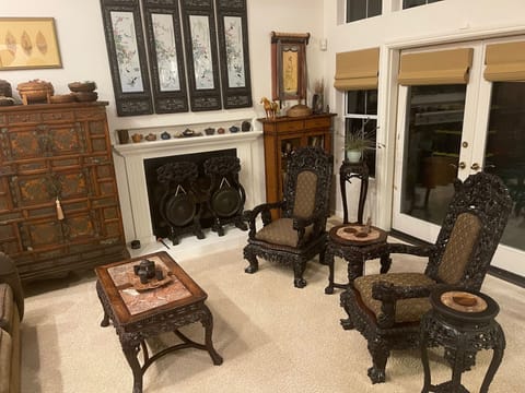 Spacious living room with high vaulted ceiling opens up to an outdoor deck/patio