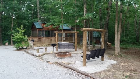 Double swings near fire pit.