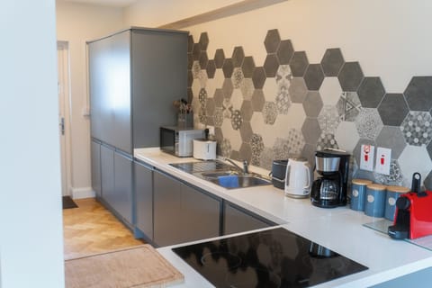 Kitchen with washer-dryer, fridge freezer, oven, microwave and hob