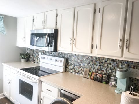 We have a glass top stove with oven, large microwave, and plenty of counter.