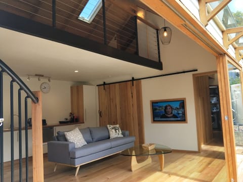 Open plan living/kitchen dining with wooden sliding doors onto outdoor area