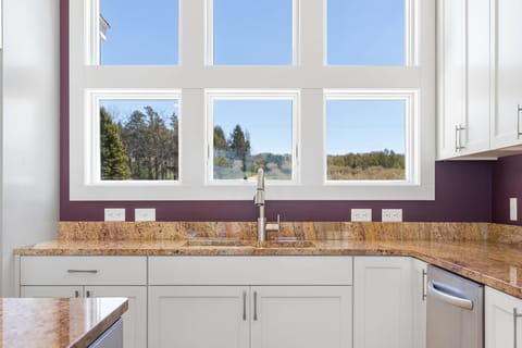 The kitchen sink overlooks a private cherry orchard across the street.