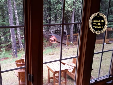 View from sunroom to sitting area and pathway to river