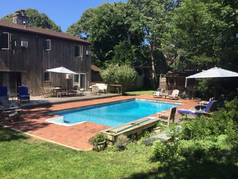 Large backyard w/several areas to lounge, grass area 2 play, and outdoor shower