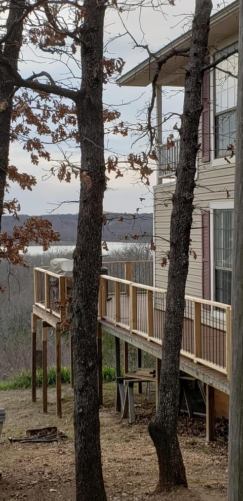 Side view of deck and house with water in background