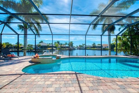 Relax at Tropical Breeze: private pool with spa, stunning wide canal view, and endless Florida sunshine. The perfect villa retreat for your Cape Coral getaway.