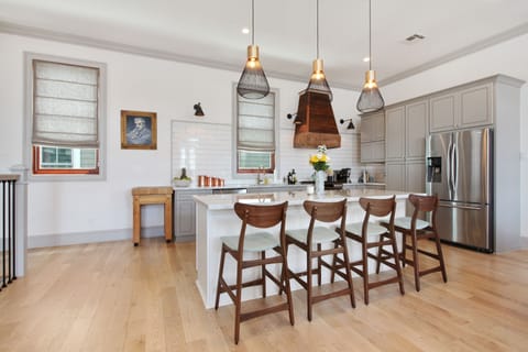 Custon Kitchen with marble counters, handmade hood and gas range.