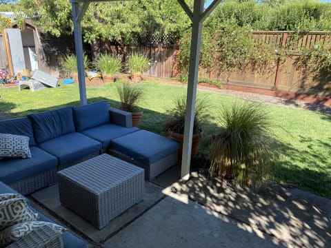 Spacious backyard with patio seating, table that seats 8 , bbq and string lights