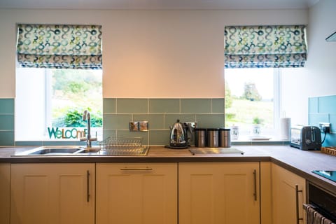 Fraser cottage kitchen with views across fields and towards Dunmore Castle