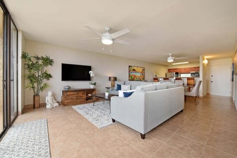 Spacious living area with sofa, armchairs, and dining view.