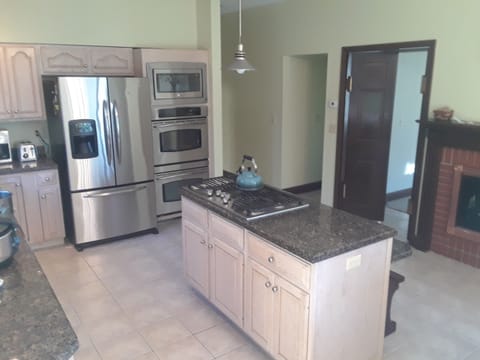 The Hermitage Hills Estate kitchen has a five burner gas cooktop.