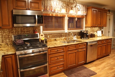 Full kitchen with gas stove, microwave, dishwasher and granite counters