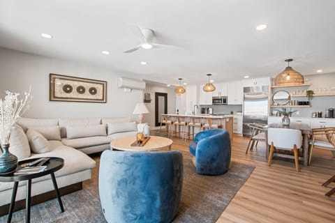 Newly furnished living area with ample seating, large flat screen television, air conditioning, and access to patio just off of the beautiful, open kitchen.