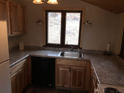 Kitchen w/ microwave, stove, refrigerator, dishes, pots pans, crock pot, etc...