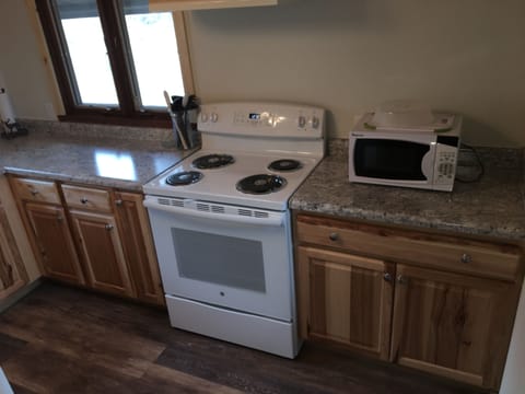 Kitchen w/ microwave, stove, refrigerator, dishes, pots pans, crock pot, etc...