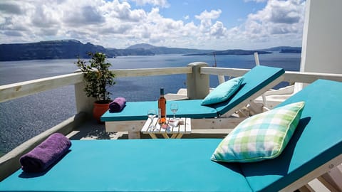 terrace with sunbeds, lolcano and city view