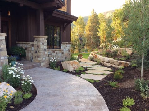 Front entry to the house with access to grass yard and back stone patio.
