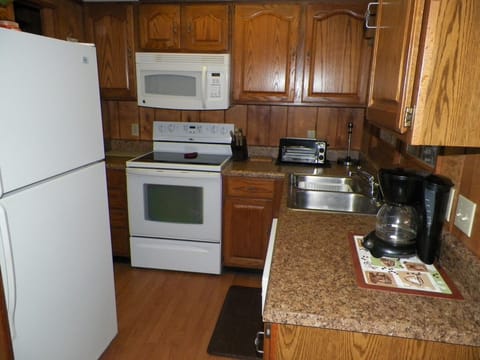 Furnished modern kitchen linens,microwave, toaster oven,coffeepot,dishwasher, dinnerware, and cookware
