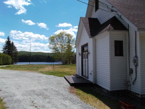 Front of house with view of lake on other side of peninsula.