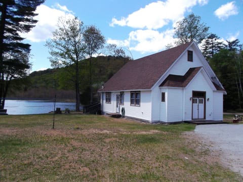 Front of house with private lakefront in back.