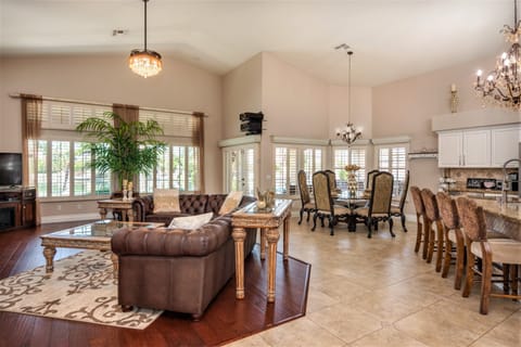 Open concept great room has many large windows overlooking the lake and pool.