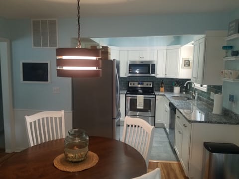 New kitchen with granite and stainless appliances.
