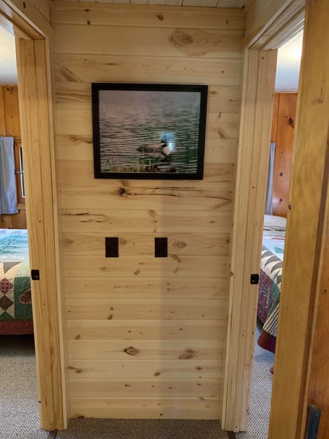 Hallway looking towards bedrooms. New knotty pine interior walls and new carpet