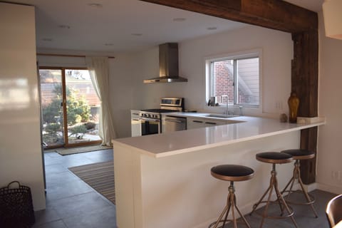 Dining area opens up to the kitchen with a view of the garden. 
