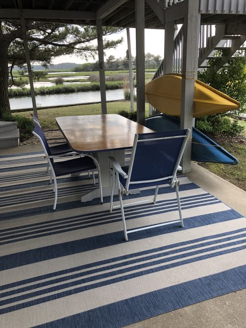 Lower patio-under screened-in porch. 
A shady oasis with water views + kayaks.