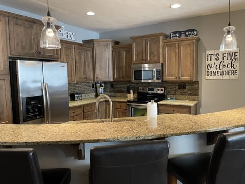 Fully equipped kitchen with granite countertops and stainless steel appliances