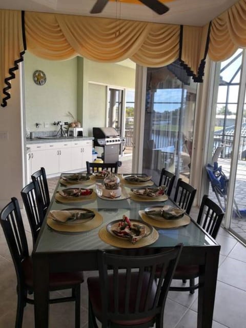 kitchen table seats 8 and leads to outdoor kitchen