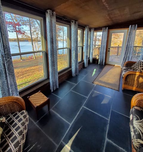 The sun room has floor to ceiling windows to take in the beautiful view
