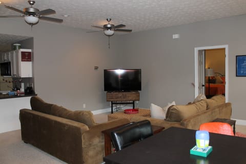 Basement w/ card table. Wet bar to the left of TV in this picture.  Full fridge.