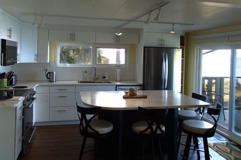 Kitchen and dining area. There are more stools.