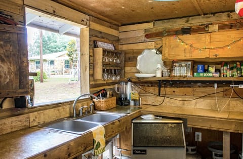 Outdoor kitchen/bar with commercial ice maker.
