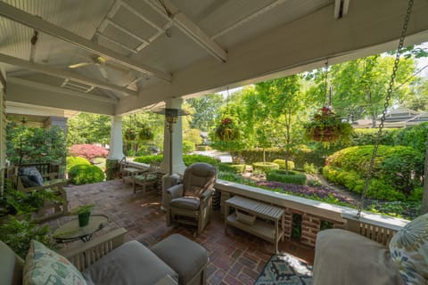 Front porch overlooks a beautifully manicured, private garden