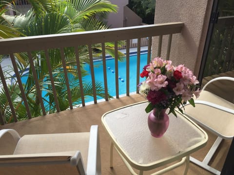 Balcony off Kitchen and Bedroom overlooking the pool