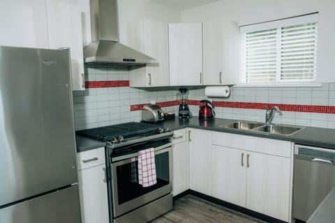 Kitchen with full size fridge, gas stove and dishwasher