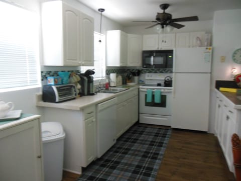 Kitchen with dishwasher, garbage disposal, electric stove and fridge