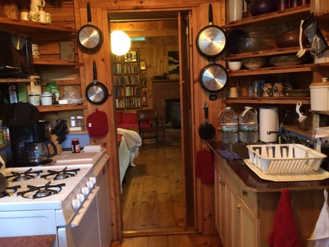 Fully equipped kitchenette in studio looking toward living area