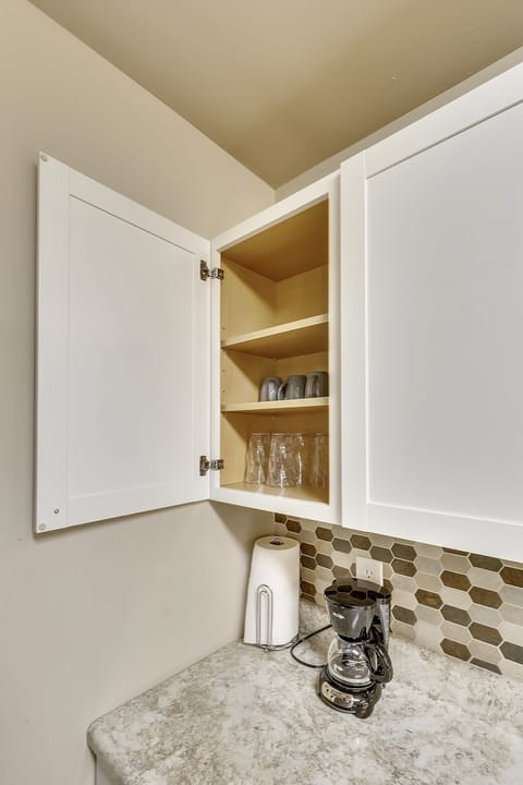 Glasses, coffee mugs and coffee maker.