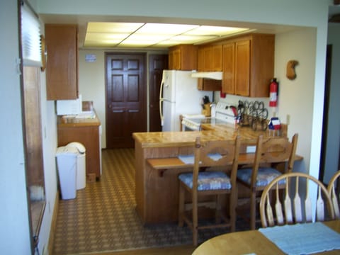 KITCHEN FROM DINING AREA AND SNACK BAR