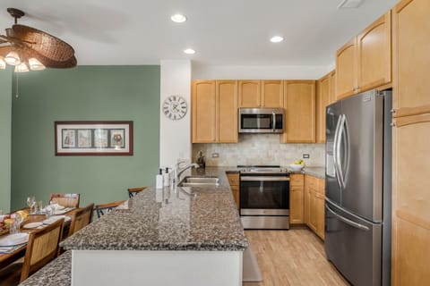This chef’s kitchen features granite countertops, stainless-steel appliances, and generous prep space for every culinary craving.