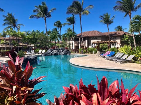 Enjoy sunny days at the resort’s lagoon-style pool surrounded by tropical gardens and swaying palm trees—just steps from your door.