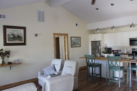 Common living room with four reclining chairs, internet TV, and full kitchen.