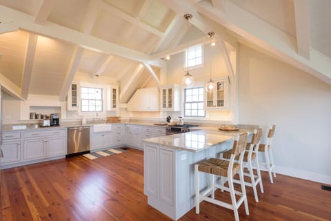 Kitchen with Sub-Zero fridge, gas range, granite counters and seating.