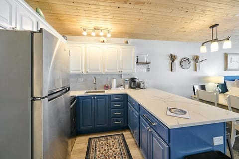 It features a range oven, cooktop, fridge, microwave and plenty of dishes and cookware. 