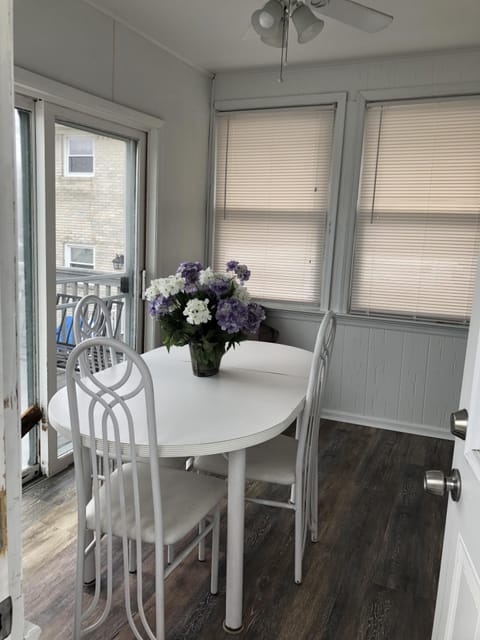 Back sunroom w/ceiling fan&indoor seating for dining. Slider and door to deck. 