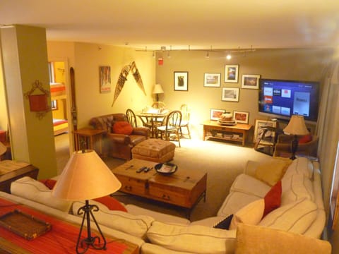 Mid floor main living room with big couch and  large screen TV