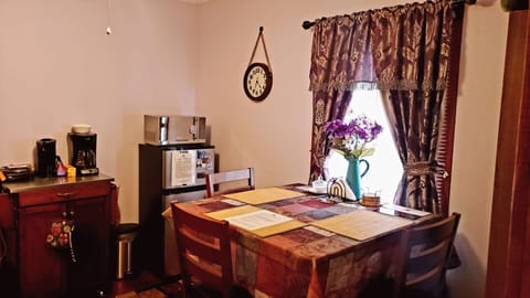 Dining area: high table &3 chairs, small fridge, microwave, coffee maker, kettle